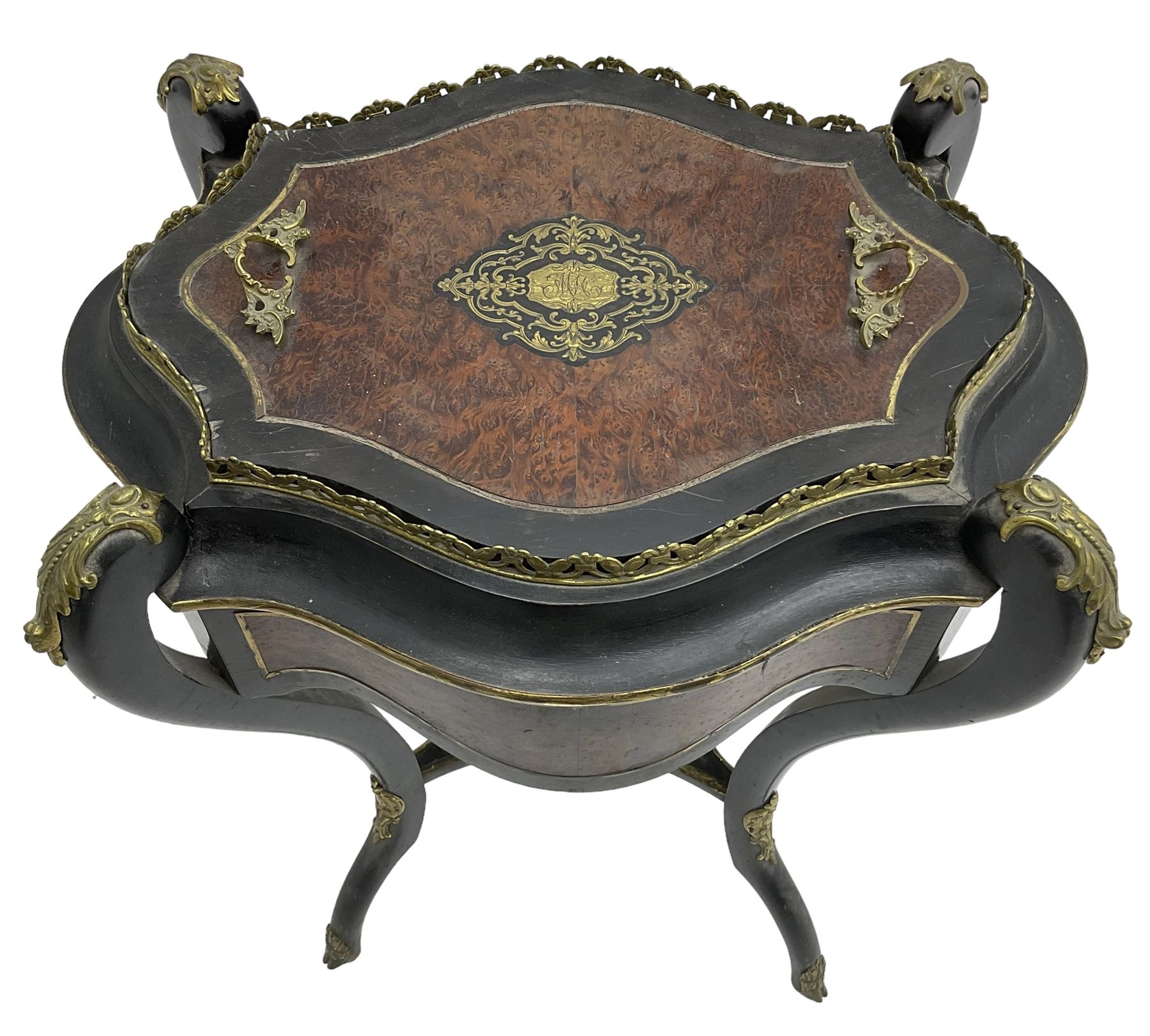 Late Victorian ebonised and amboyna wood jardinière planter, shaped form with removable lid inlaid with scrolling brass work and mounted by ornate cast gilt metal handles, the frieze rails inlaid with amboyna panels and brass stringing, on cabriole supports united by under-tier, decorated with cast gilt metal acanthus leaves and hooved feet caps