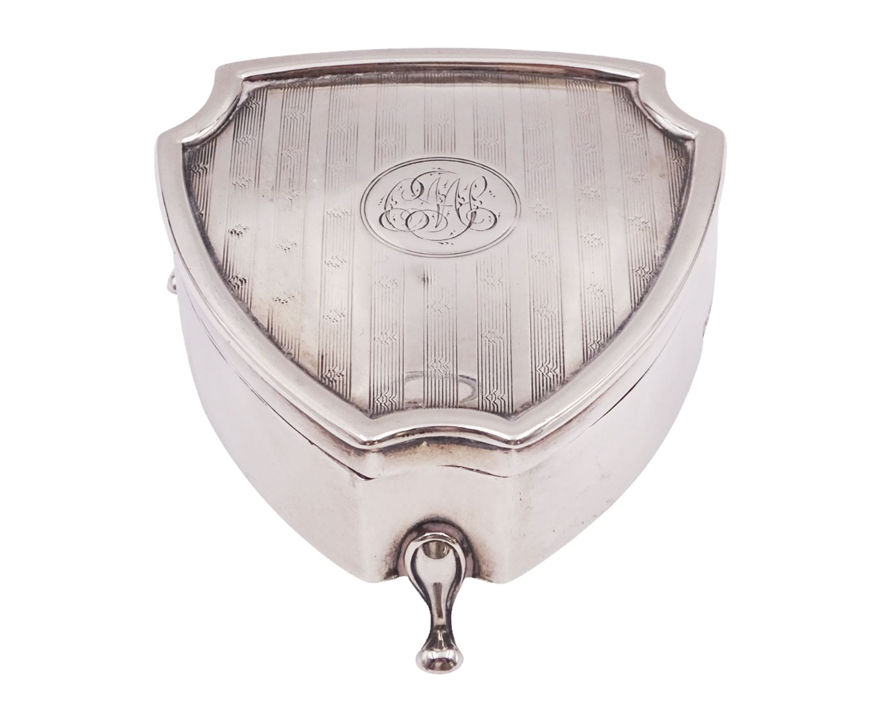 Early 20th century silver mounted trinket box, of shield form, with engine turned decoration and engraved circular cartouche to hinged cover, opening to reveal green velvet interior, upon three pad feet, hallmarked Walker & Hall, Sheffield 1914, H3.5cm, W7cm