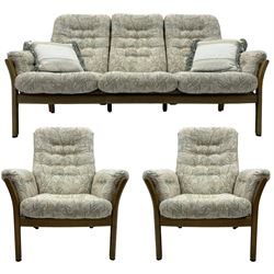 Ercol - mid-century three-piece ash lounge suite, featuring a three-seater sofa upholstered in a floral and woodland bird pattern (W197 x D95 x H99 cm), pair of matching armchairs with drop-in cushions (W88 x D90 x H98 cm).