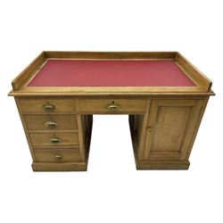 20th century oak desk, moulded rectangular top with raised back and inset leather writing surface, fitted with five drawers and single panelled cupboard, on moulded plinth base