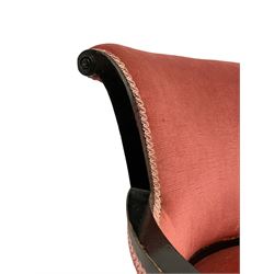 Early 20th century ebonised hardwood-framed armchair, rolled back and curved arms, upholstered in pink fabric, on square tapering front supports with spade feet, brass and ceramic castors 