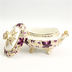 Pair of early 19th century porcelain sauce tureens and covers on stands, possibly Coalport, painted with bands of purple and gilt fruiting vines, within gadroon borders, the stands with naturalistic oak leaf and entwined moulded  handles, the covers with flower knop handles, stand L24cm, overall H18cm