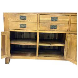 Oak dresser, upper section with twin glazed cupboard doors and central shelving with two trinket drawers, lower section fitted with six drawers over three panelled cupboard doors, raised on shaped feet 