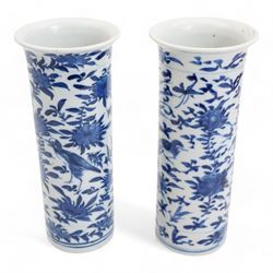 Pair of 19th century Chinese blue and white sleeve vases, each of cylindrical form with flared rim, painted with exotic birds amongst foliate sprays, four character Kangxi mark beneath, H21cm