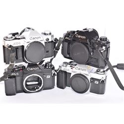 Four Canon SLR camera bodies, to include AT-1 in black and silver finish, serial no. 220197, A-1 in black, serial no. 508829, ad two AL-1 bodies, one black and one silver and black, serial nos. 1102614 & 3043913