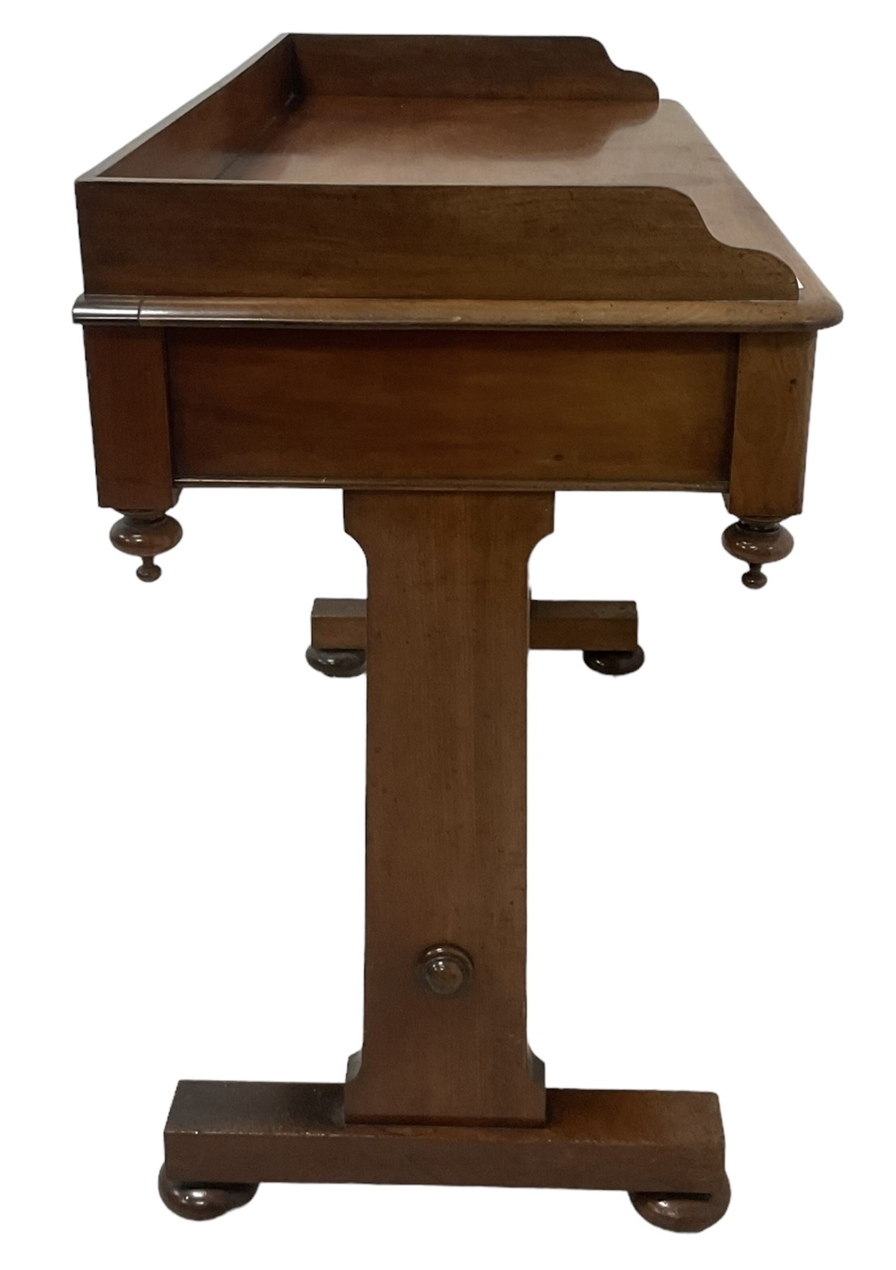 Victorian mahogany washstand, three-quarter raised gallery back, rectangular top with over two drawers, on shaped end supports united by ring-turned stretcher