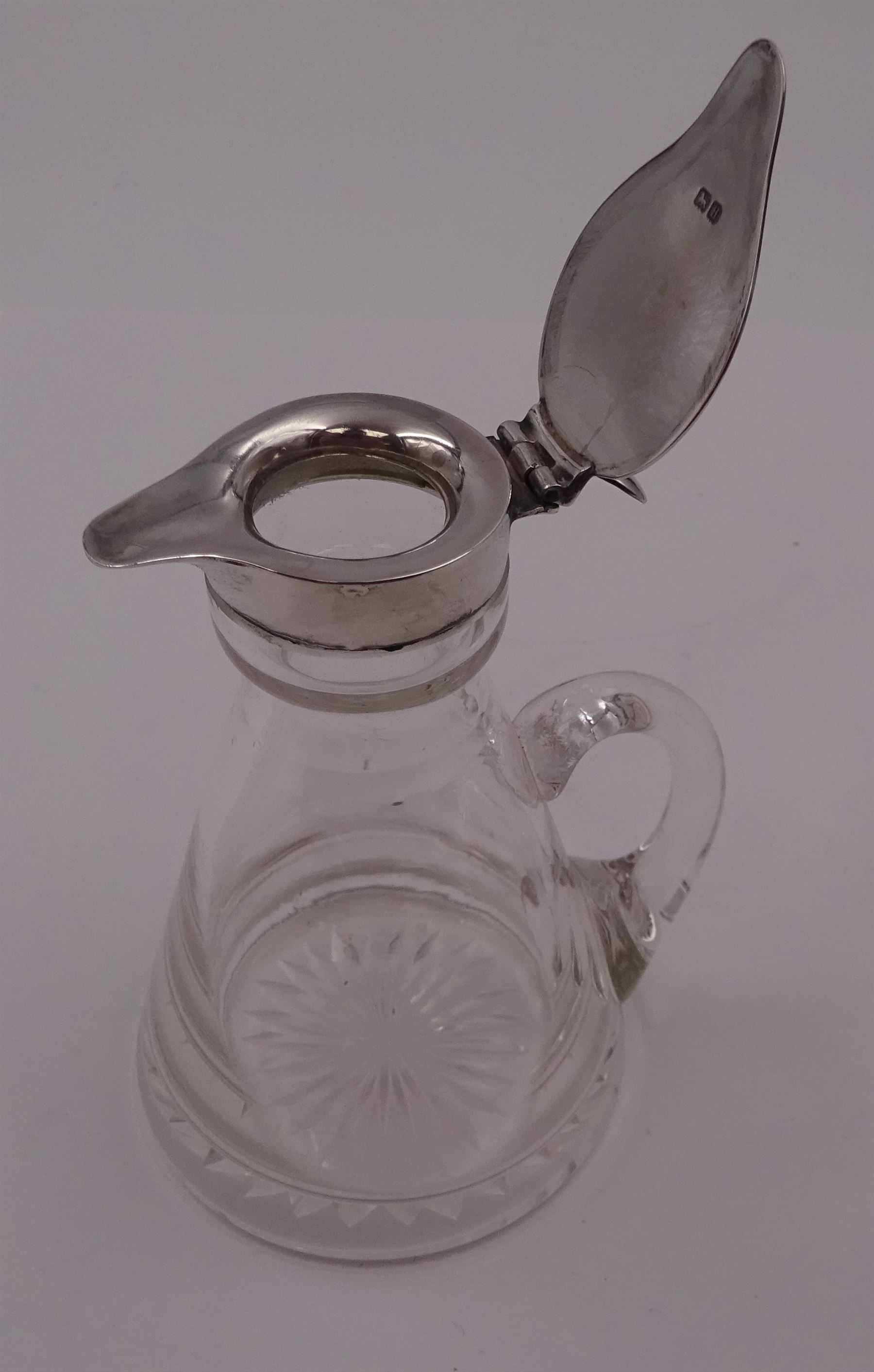 1930s silver mounted glass whiskey tot, with C handle and star cut base, the silver collar and cover with thumbpiece, hallmarked S Blanckensee & Son Ltd, Birmingham 1932, including thumbpiece H10.5cm