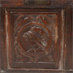 18th century carved oak coffer or chest, sloped hinged lid over panelled front, carved with three Northern European portraits with foliage surrounds decorated with birds, fitted with wrought metal carrying handles, on fluted stile supports 