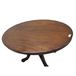 Victorian mahogany loo or dining table, oval moulded tilt-top on turned pedestal, four out splayed supports with scrolled carved terminals (137cm x 101cm, H75cm); together with set of four Victorian dining chairs upholstered in pale buttoned fabric, on turned front supports with brass and ceramic castors  