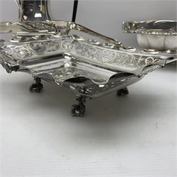 Edwardian silver plated swing handled basket, with pierced sides, engraved May 18 1904, with engraved initial A to handle, upon four ball and claw feet, together with other silver plated item including a similar swing handled basket, with embossed floral border, upon a rectangular pedestal, an egg coddler, with lion mask handles, hot water pot and a moulded glass biscuit barrel, coddler H22cm