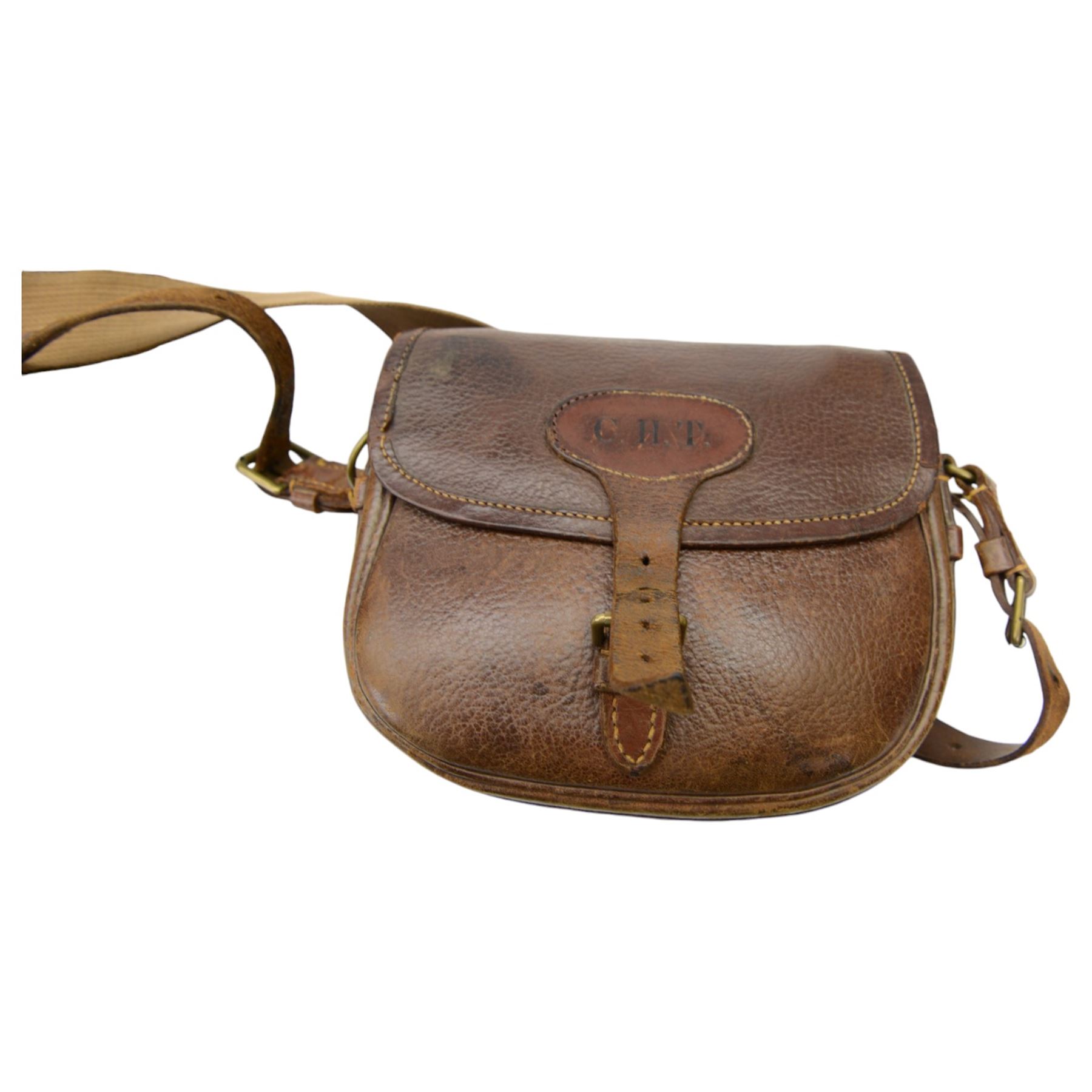 Brown leather cartridge bag on a canvas strap, together with Parker-Hale gun cleaning kit, leather cartridge case and other gun related items