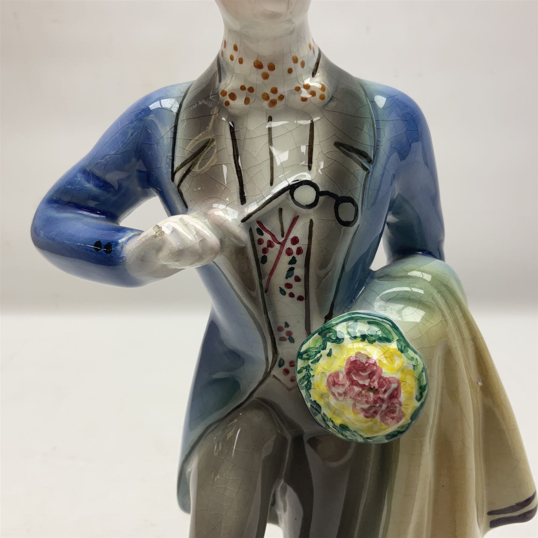 Goldscheider figure, modeled as a gentleman with flowers, upon a circular base, with printed mark beneath, H25cm