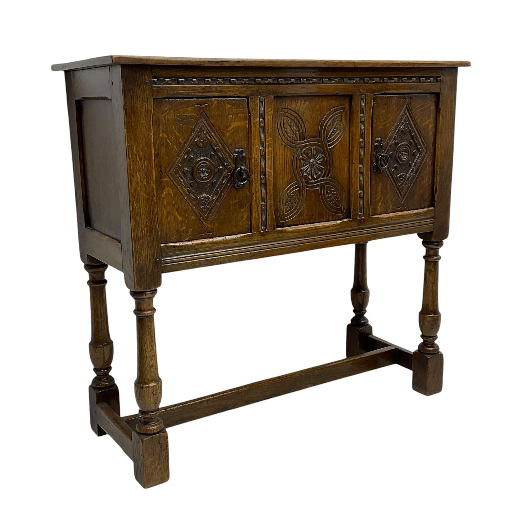 Jacobean design oak cupboard, rectangular top over two doors and central panel, carved with interlacing design with flower head and lozenges, on turned supports united by H-stretchers 