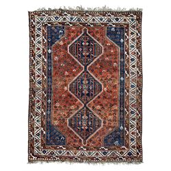 Persian Shiraz crimson ground rug, three connected lozenge medallions on a field decorated with small bird motifs, the main border decorated with repeating geometric motifs, within hooked guard stripes 