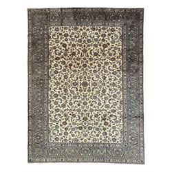 Persian Kashan ivory ground carpet, the busy field decorated with scrolling and interlaced...