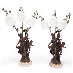 Pair of large bronzed resin figural table lamps, modelled as a young woman and cherub, issuing three naturalistic branches, entwined with flowering tendrils, with three frosted glass shades, on simulated marble base, H84cm (2)