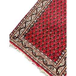 Persian Mahal red ground rug, central floral design pole medallion on a field decorated with flowerheads and foliage, the border decorated with trailing leafy branch and flowerheads 