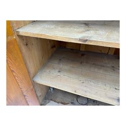 Large 19th century pine cupboard, rectangular top over two panelled later doors, enclosing four open shelves, on plinth base