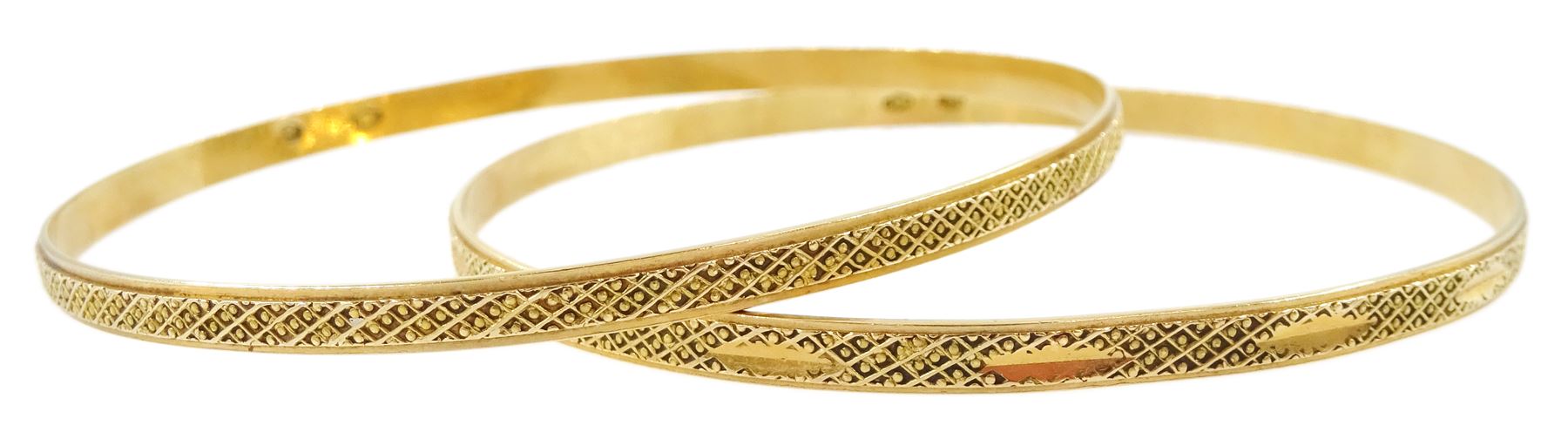 Two Middle Eastern 18ct gold bangles, with bead decoration