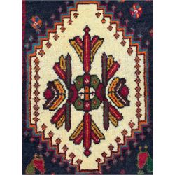 South West Persian Qashqai red ground runner, the crimson field decorated with three connected lozenges, surrounded by small stylised motifs of bird and plants, indigo spandrels with further stylised motifs, the border with repeating floral design 