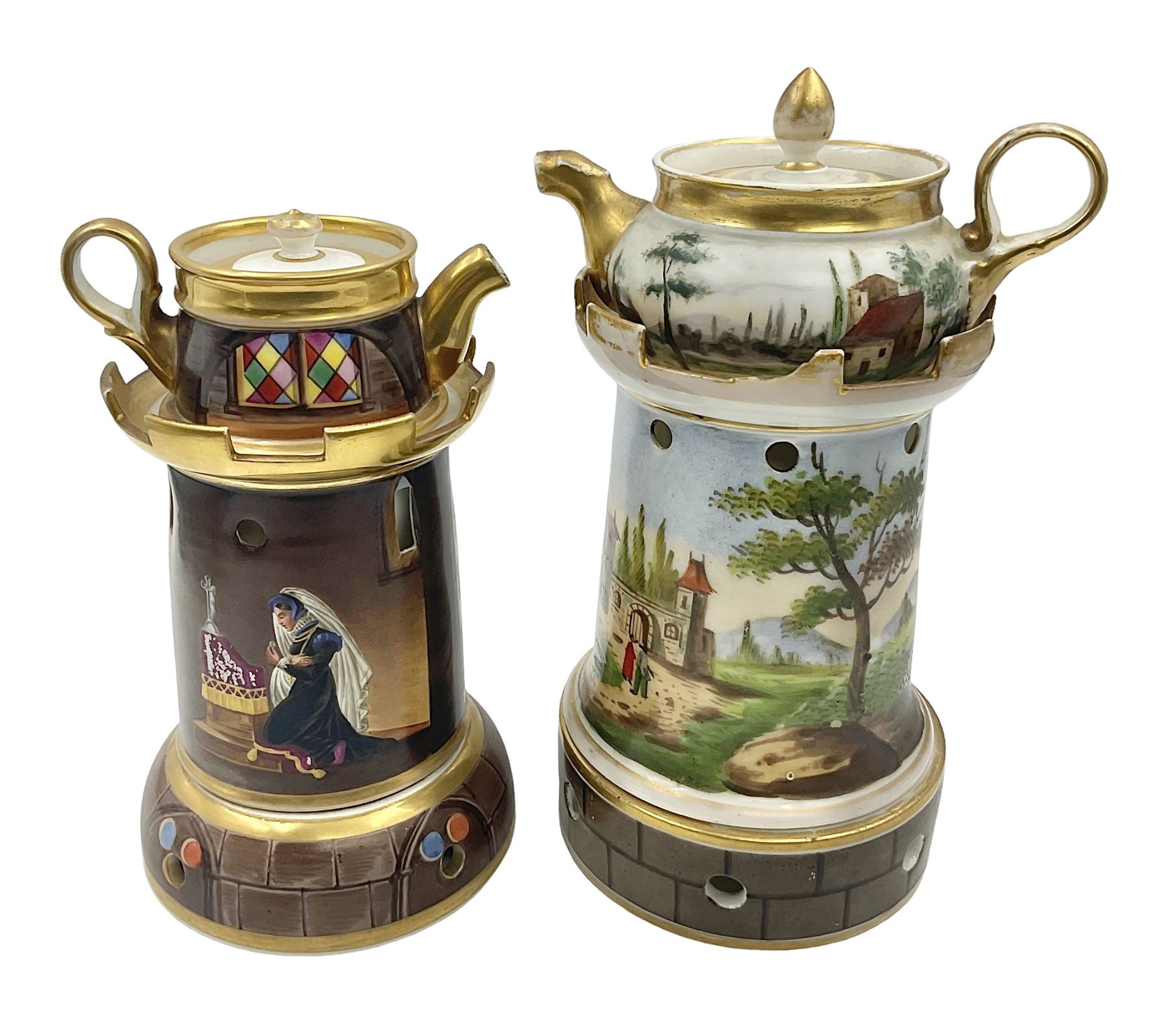 Two 19th century continental teapots and warmers, each teapot upon a cylindrical warming base in the form of a castle, hand printed with landscapes and figures in a religious pose, largest H22cm 