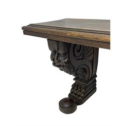 Victorian oak bench, moulded rectangular top, on mask and scroll carved corbel supports with paw feet, rectangular platforms with rounded terminals and applied roundel 