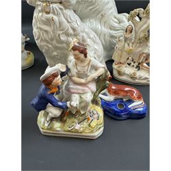 Staffordshire and Staffordshire style figures, to include a chained hound upon a blue oval base in the manner of Samuel Alcock, two pairs of seated Spaniels, a pair modelled as male figure and milk maid with cows, pair of recumbent Greyhounds, etc.