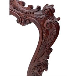 Large carved hardwood wall mirror, shaped floral carved pediment over trailing and scrolled foliage decoration, plain mirror plate 