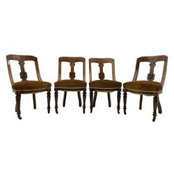 Set of four late Victorian walnut dining chairs, carved with stylised floral decoration and scrolling branches, upholstered seat, on turned and fluted supports 