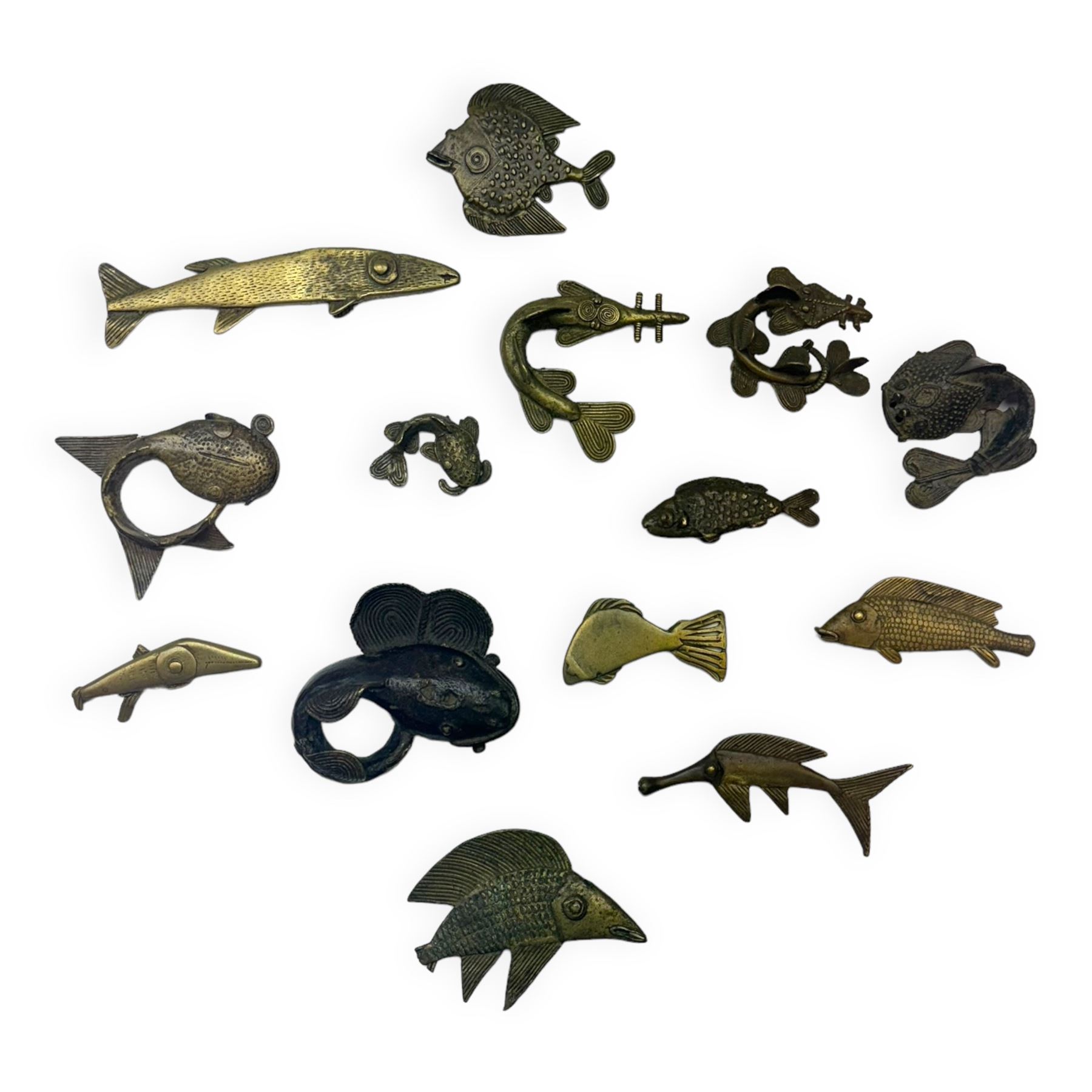 Fourteen Ashanti brass and other metal gold weights, modelled as various fish, including Silure fish, one example bearing label stamped Sotheby's 3 Dec 1984, largest example L8cm