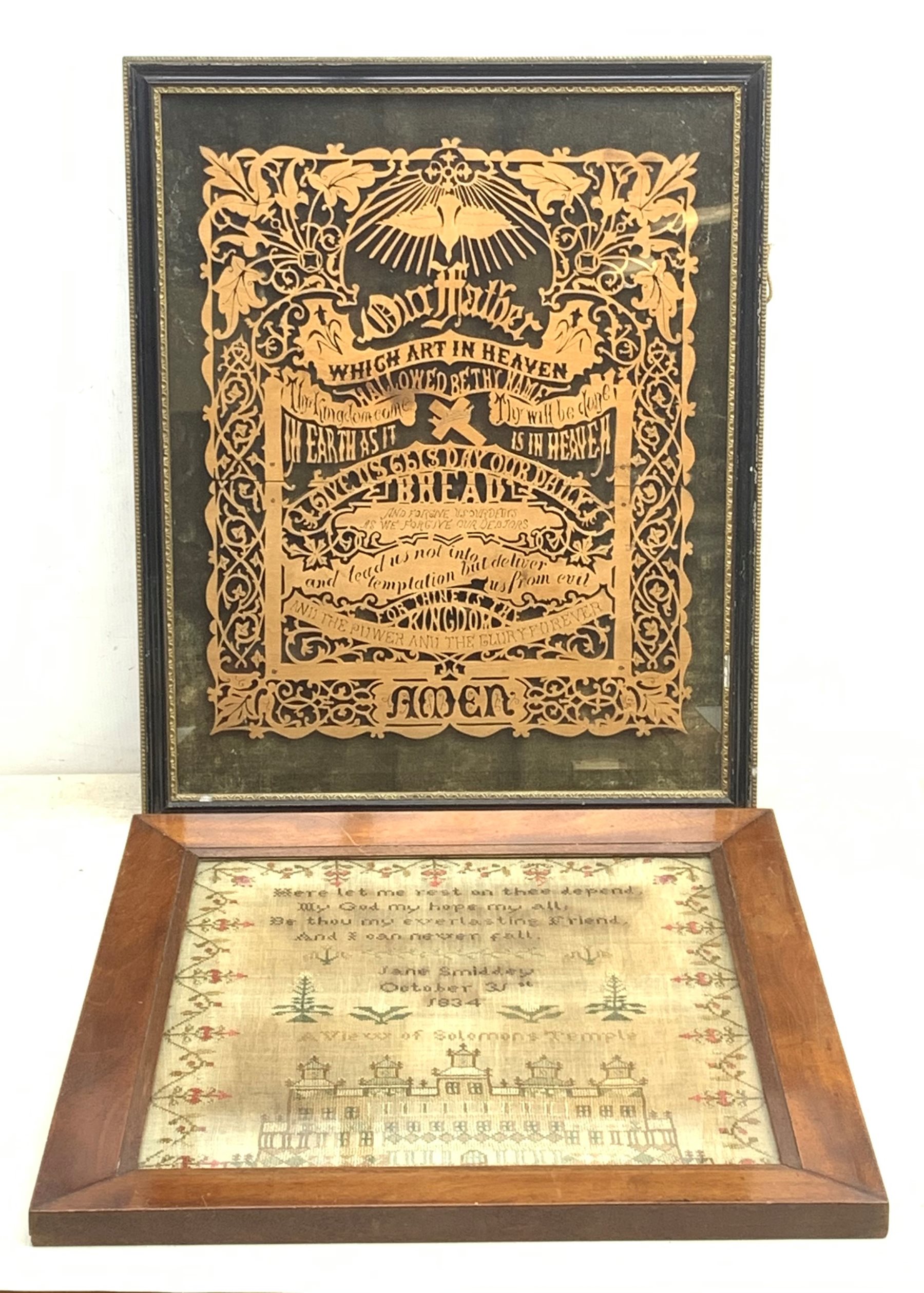 An early 19th century framed and glazed sampler, detailed with floral motifs and bands, religious text and building 'A View of Solomon's Temple', stitched by Jane Smiddey and dated October 31st 1834, H41cm, together with a framed and glazed religious pierced woodwork plaque detailed with the Lords Prayer. 