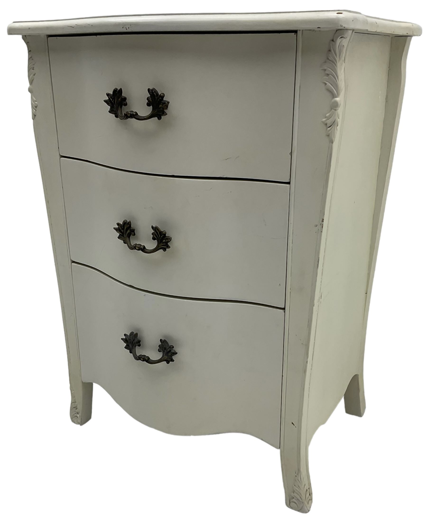 French design cream painted bedside chest, fitted with three drawers, with foliage decoration 