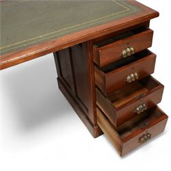 Early 20th century walnut twin pedestal desk, moulded rectangular top with inset green leather writing surface, fitted with eight drawers with brass cup handles, on plinth base