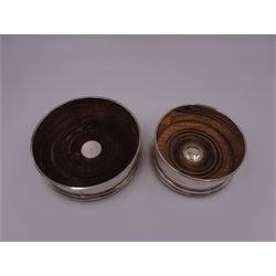 Two modern silver mounted bottle coasters, each with a turned wooden centre, both hallmarked WW, London 1988 & 1996, largest example D12.5cm