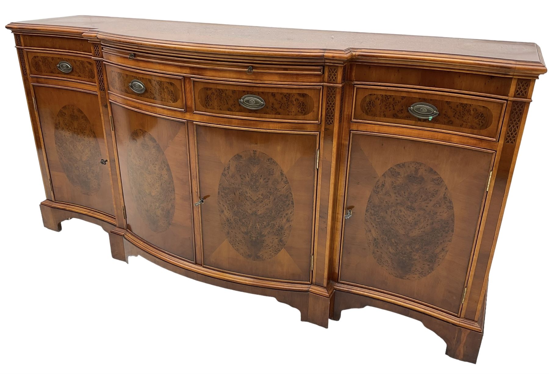 Wade - Georgian design yew wood bow-fronted sideboard, projecting moulded top over four cockbeaded frieze drawers, the central two with pull-out slides, four cupboards below with figured veneers, raised on bracket feet