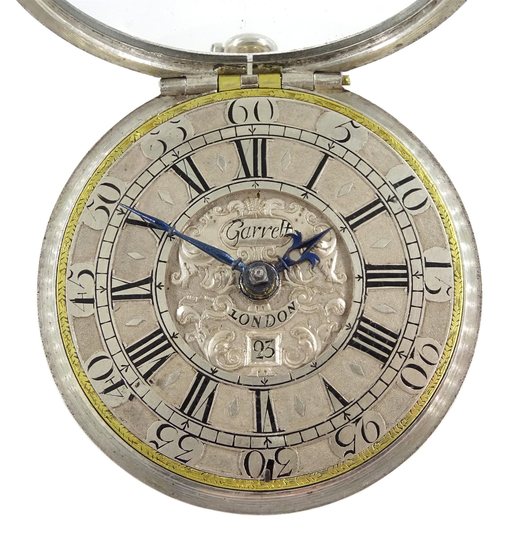 Late 17th/ early 18th century silver pair cased verge fusee pocket watch by Jonathan Garrett, London, circa 1695, Egyptian pillars, pierced and engraved balance cock decorated with two masks, silver champleve dial with gilt border, Roman hours and outer Arabic minute ring and date aperture, blue steel tulip and poker hands, dial signed Garrett London