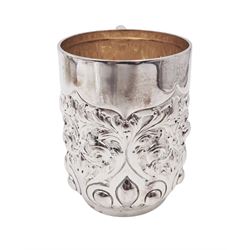 Late Victorian silver christening mug, with C handle and gilt interior, the body profusely embossed with floral and foliate decoration, hallmarked Atkin Brothers, Sheffield 1897, H10cm