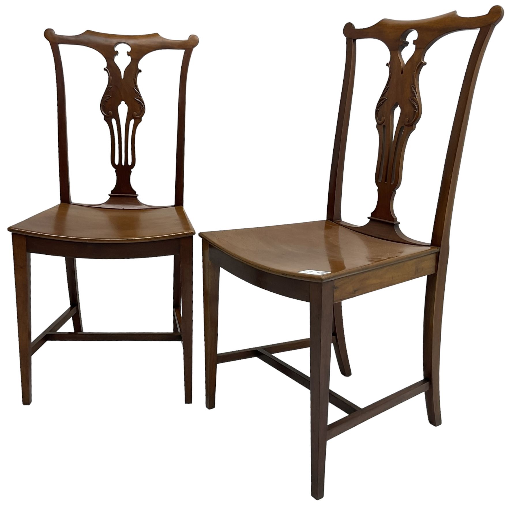 Early 20th century pair of mahogany side chairs, shaped cresting rail over shaped and pierced splat carved with curled leaf decoration, dished seat on square tapering supports united by H-stretchers 