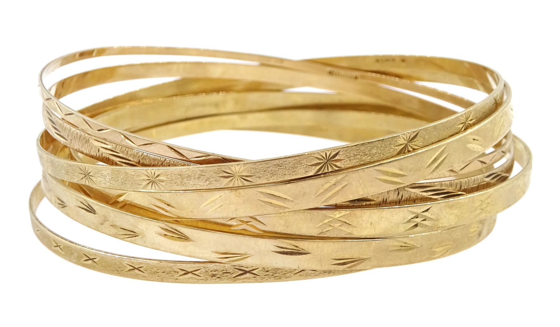 Seven 9ct gold bangles, with engraved decoration, all hallmarked