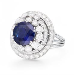 Platinum Ceylon sapphire and diamond, swirl design cluster ring, round cut sapphire of 4.56 carat, with CGL report, with baguette and round brilliant cut diamond surround, total diamond weight approx 4.30 carat