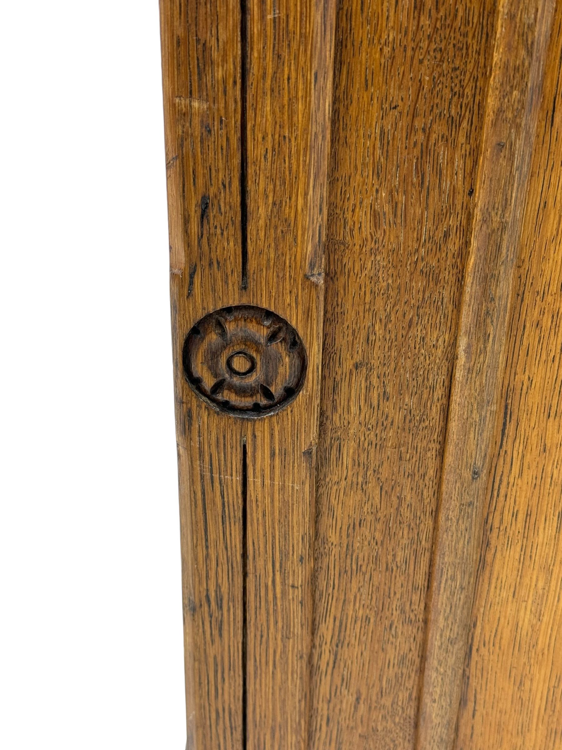 Late Victorian oak twin pedestal desk, chamfered rectangular top over three convex front edge drawers and two panelled cupboards, flanked by carved supports with roundels and diamond motif, on bracketed plinth base