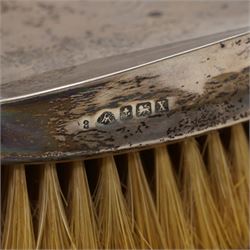 Silver photograph frame with embossed decoration and circular aperture D10cm Birmingham 1984 and a pair of silver backed gentleman's hair brushes Birmingham 1922