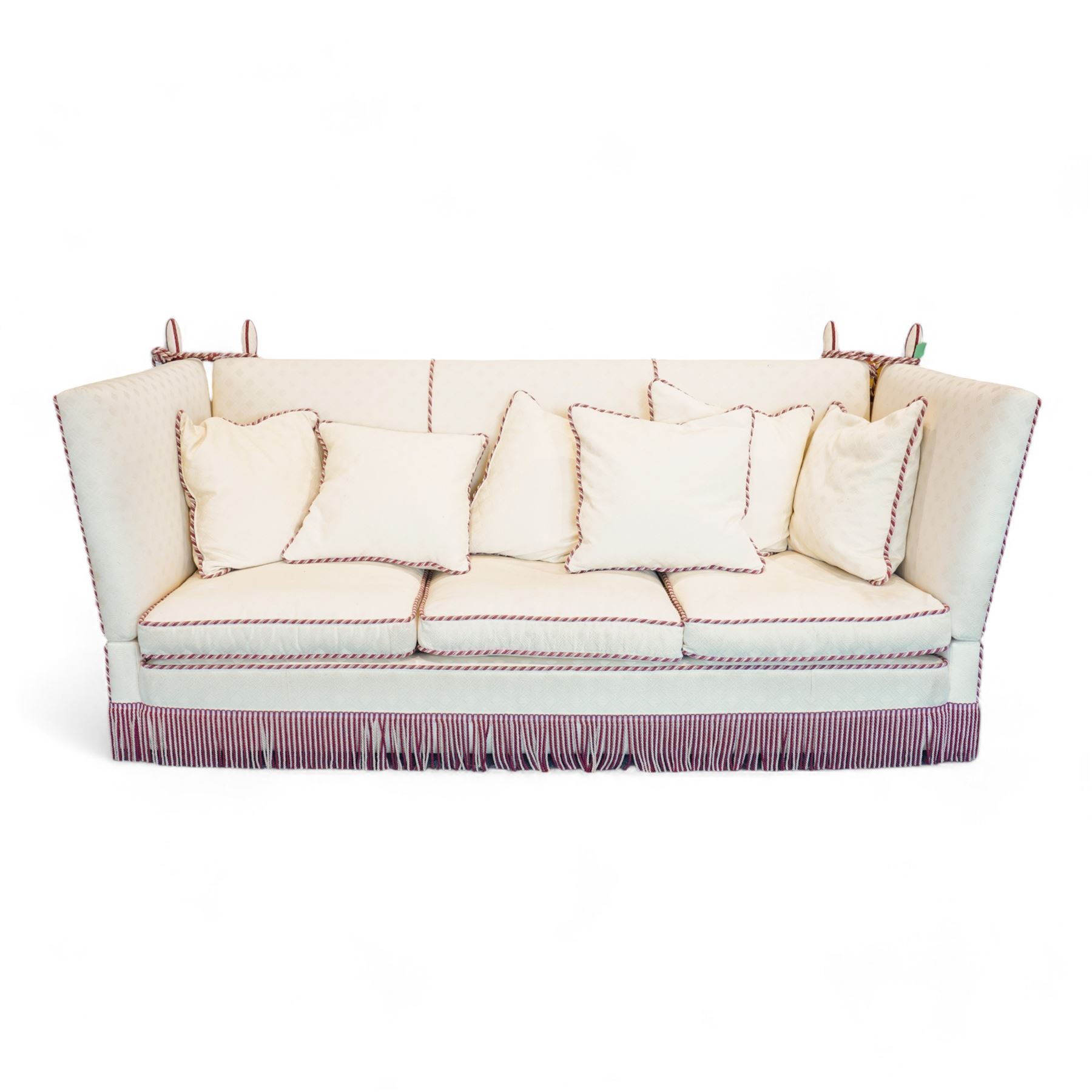 Grande Knole four-seat sofa, upholstered in geometric lozenge pattern cream fabric with burgundy and cream twist piping and fringe, on castors