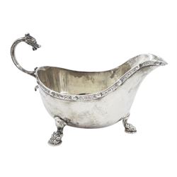 Early 20th century silver sauce boat, of typical form with flying scroll handle, the handle and feet modelled as Viking style dragon heads, hallmarked Adie Brothers Ltd, Birmingham, date mark indistinct, possibly 1940, including handle H9cm