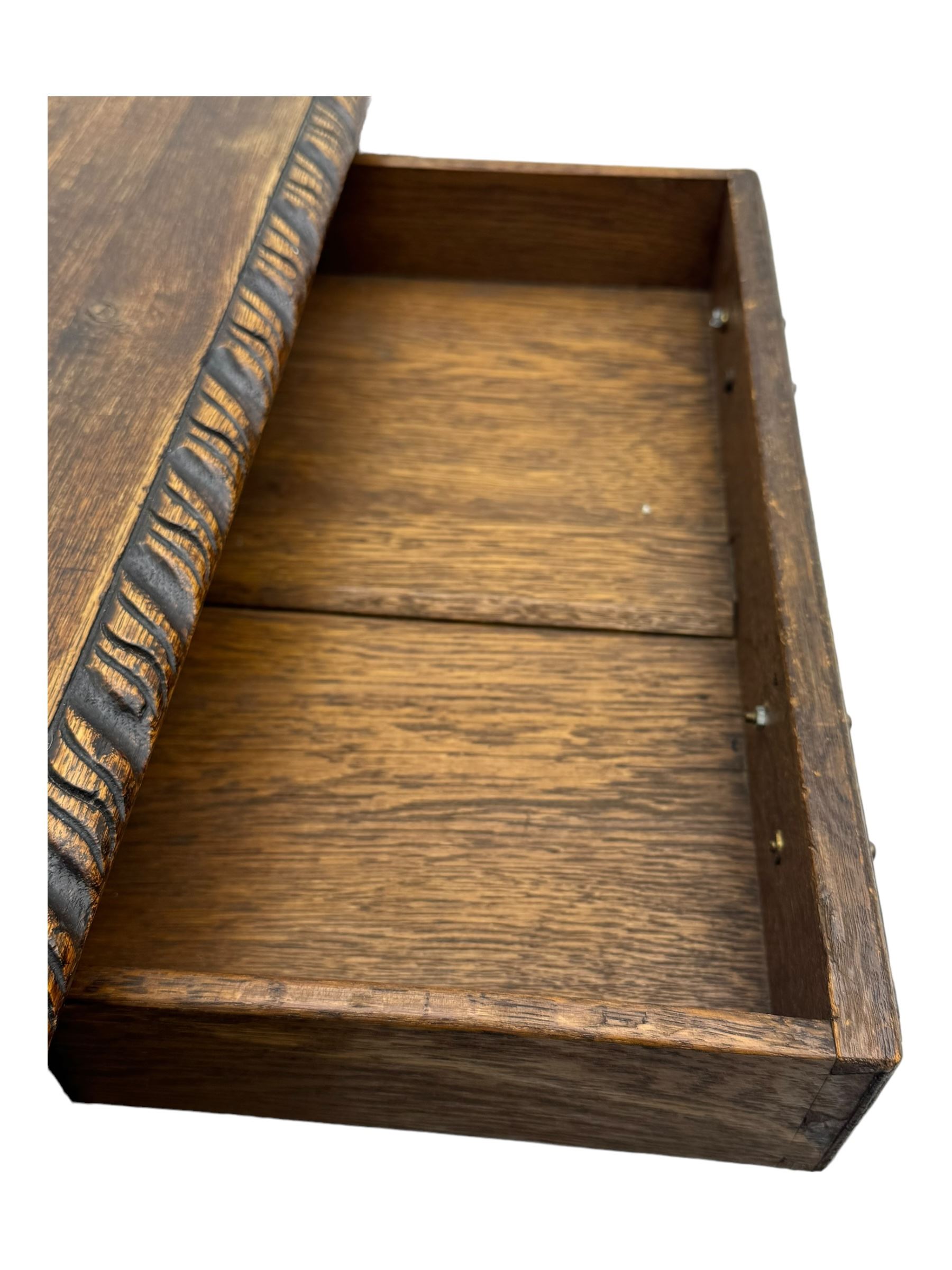 Victorian carved oak kneehole desk, the rectangular top with carved edge, above central drawer with carved front and brass handles, central kneehole with cupboard door, flanked by two banks of three graduating drawers each with similarly carved decoration, on shaped plinth base with castors