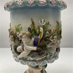 Early 20th century continental pedestal jar with cover, the bowl held aloft by four mermaids and decorated with putti playing instruments in a lake, the fluted domed cover topped with cherub playing a horn, H38cm