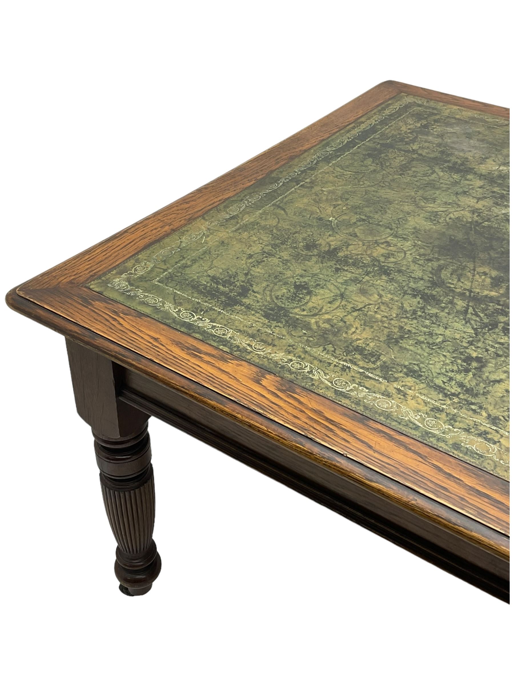 Large 10' 7'' late Victorian oak boardroom table, moulded rectangular top with inset green leather surface, on turned and reed moulded supports with brass and ceramic castors 