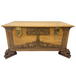 India camphor wood blanket box, moulded hinged lid, decorated with carved elephants and trees, on elephant carved feet