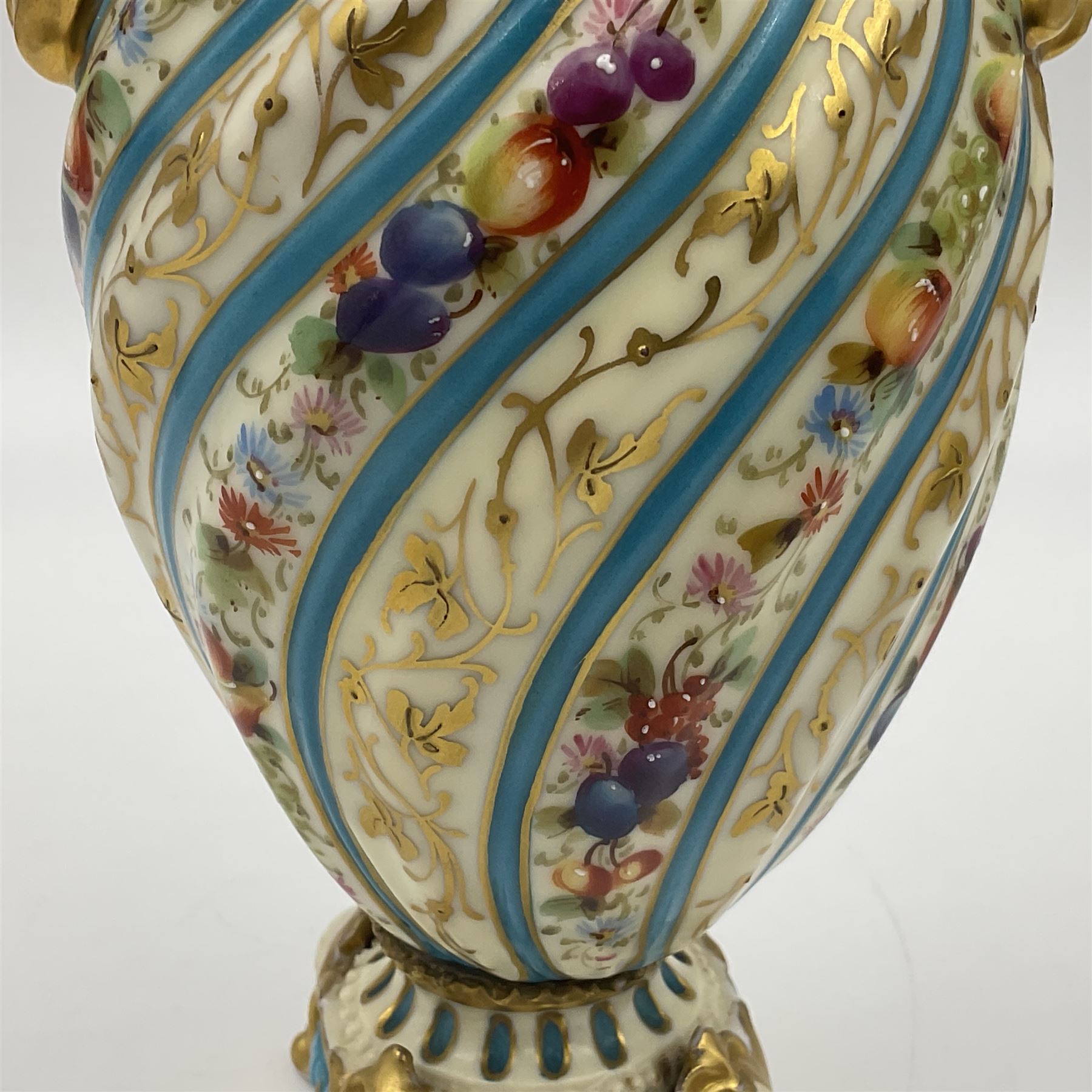 Pair of late 19th/early 20th century Sevres style vases and covers, of baluster form with gilt scroll handles and domed covers, the wrythen fluted bodies decorated with alternating bands of painted fruit and flowers and gilt vines, upon a white and celeste blue ground, with printed and impressed marks beneath, H22.5cm 