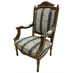 Late 20th century French design carved giltwood armchair, the cresting rail carved with scrolled foliage over foliate carved platform, upholstered in striped fabric decorated with trailing foliage and flower heads, acanthus carved arm terminals and upright supports, on turned and fluted supports 